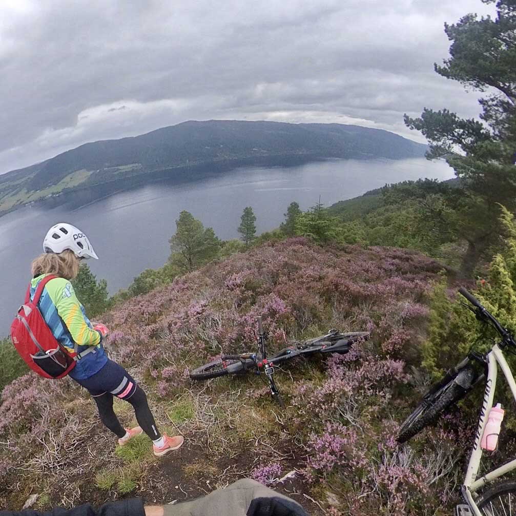 Photo of a happy cyclist with lake in background 